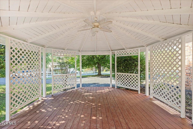 wooden terrace featuring ceiling fan and a gazebo