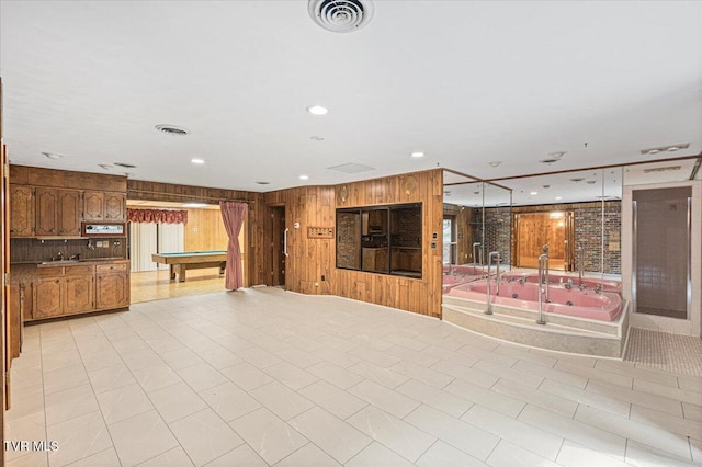 unfurnished living room featuring wood walls, billiards, visible vents, and recessed lighting