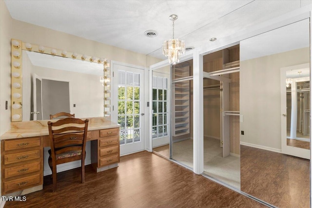 bathroom featuring baseboards, a notable chandelier, visible vents, and wood finished floors