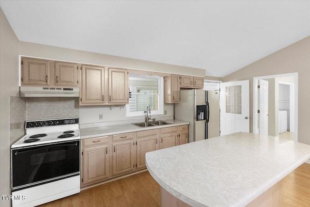 kitchen with light countertops, vaulted ceiling, a sink, white appliances, and under cabinet range hood