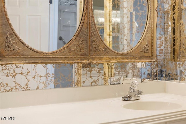 bathroom with a sink and wallpapered walls