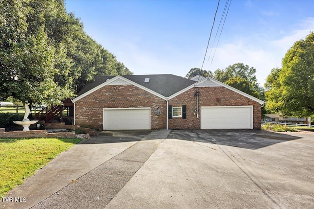 single story home featuring an attached garage and brick siding