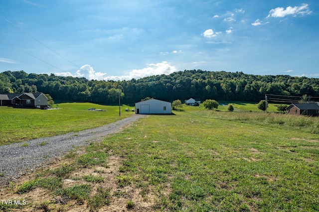 exterior space with a rural view and a view of trees