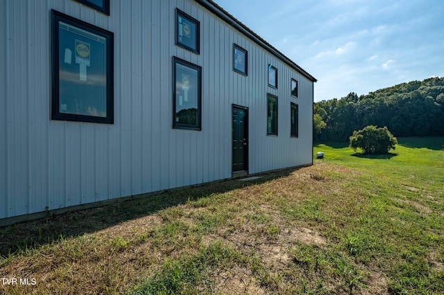 view of side of property with a lawn