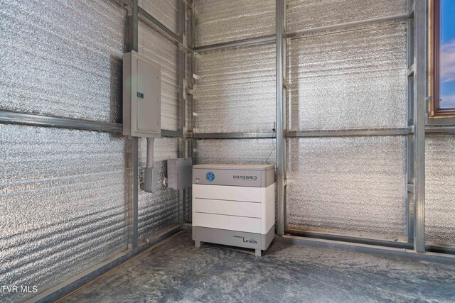 room details featuring electric panel and concrete flooring