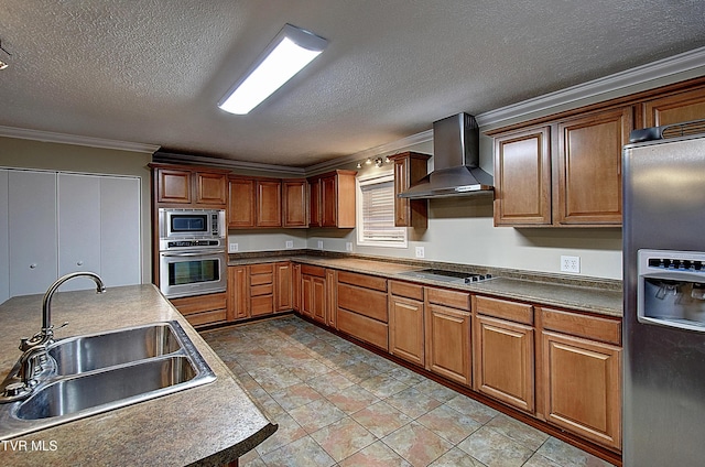 kitchen featuring a textured ceiling, a sink, appliances with stainless steel finishes, wall chimney range hood, and ornamental molding