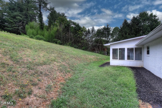 view of yard featuring a sunroom