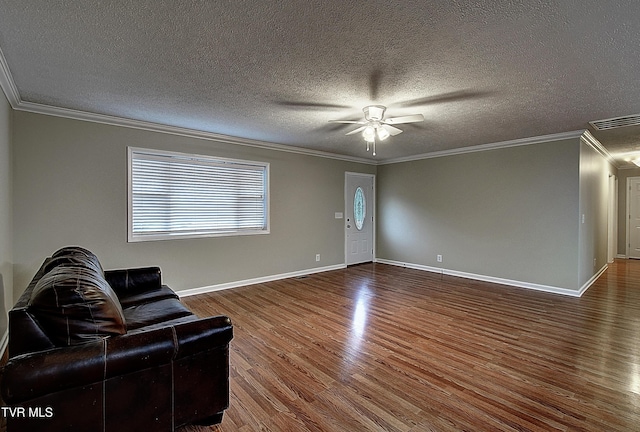 living room featuring ornamental molding, wood finished floors, visible vents, and baseboards