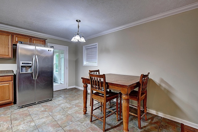 dining space featuring a notable chandelier, a textured ceiling, baseboards, and crown molding