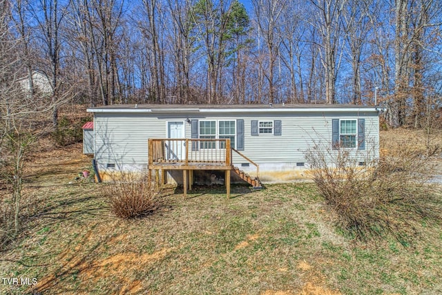 view of front of property featuring a front lawn, crawl space, a wooden deck, and stairs