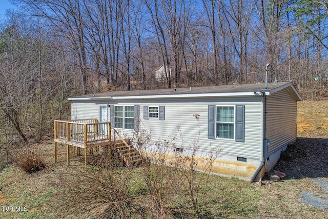 manufactured / mobile home featuring a deck, stairway, and crawl space