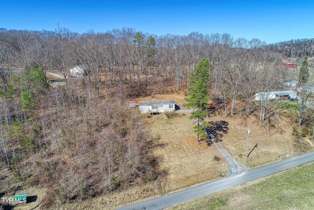 drone / aerial view featuring a forest view
