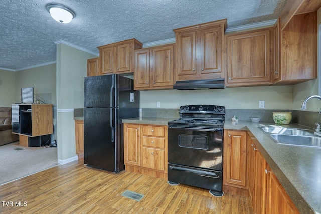kitchen with a sink, visible vents, range hood, black appliances, and crown molding