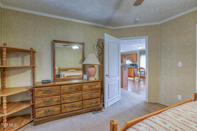bedroom featuring a textured ceiling, ornamental molding, and carpet flooring