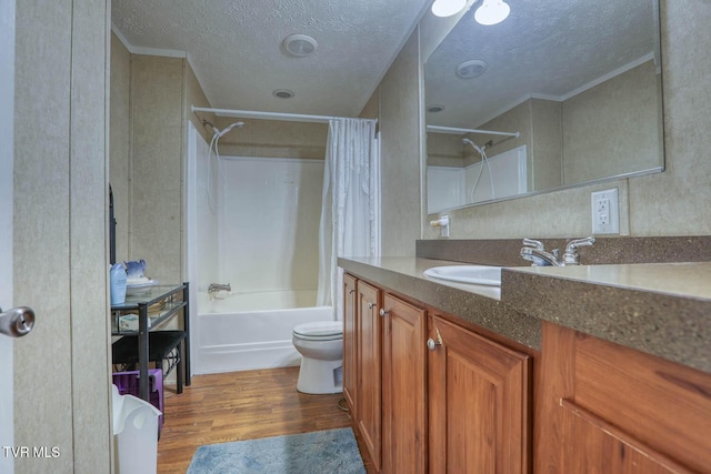 full bath featuring shower / tub combo, toilet, wood finished floors, a textured ceiling, and vanity
