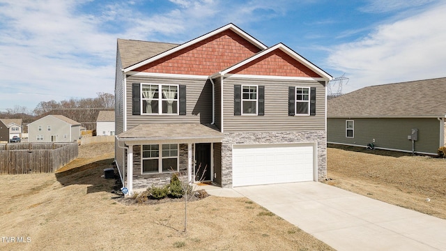 craftsman inspired home with a garage, stone siding, fence, and concrete driveway