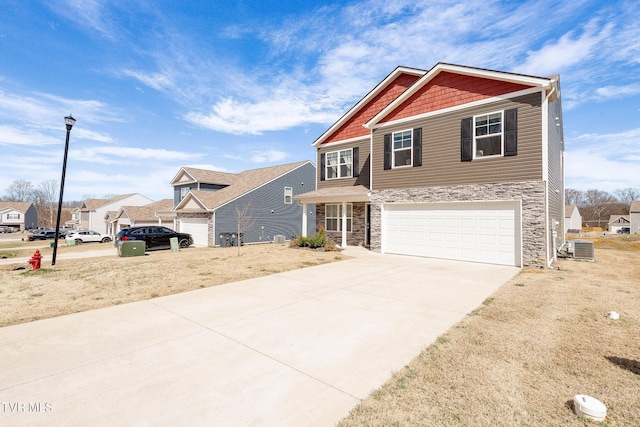 craftsman inspired home featuring a garage, stone siding, central AC, and concrete driveway