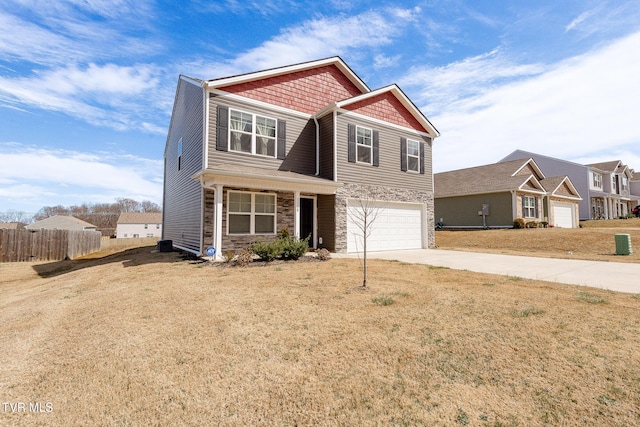 craftsman inspired home with a garage, fence, stone siding, concrete driveway, and a front lawn