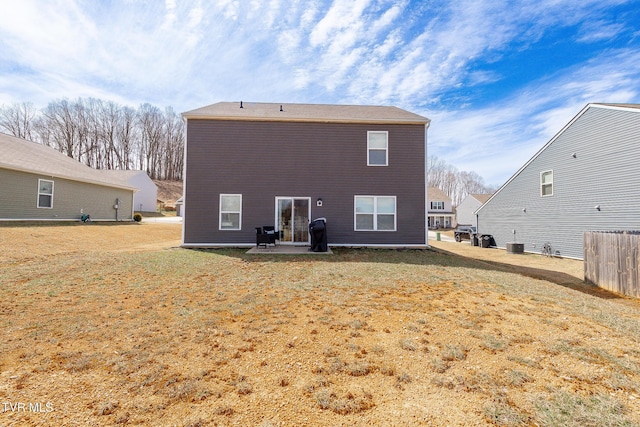 rear view of house featuring a patio, a yard, and central air condition unit