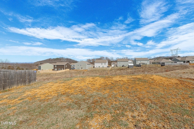 view of yard with a residential view and fence