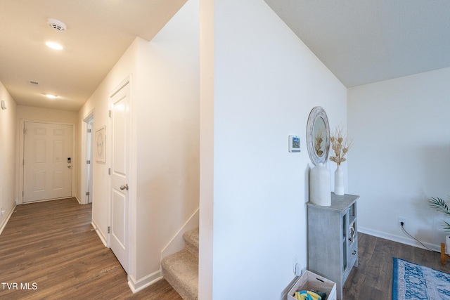 hall with dark wood-type flooring, stairway, and baseboards