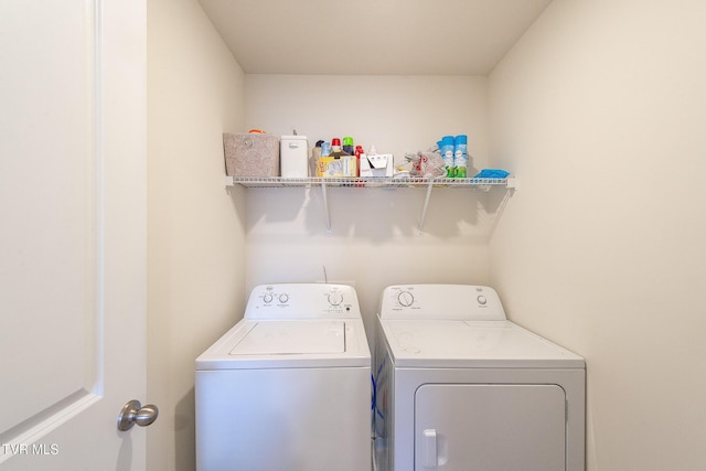 washroom featuring washer and dryer and laundry area