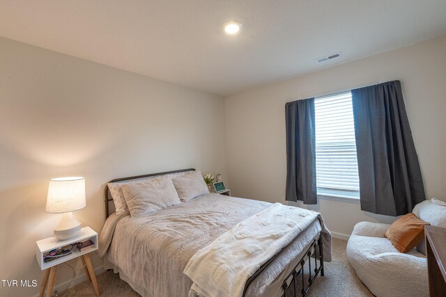 carpeted bedroom with visible vents and baseboards