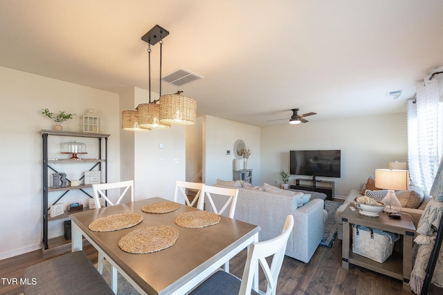 dining area with dark wood-style flooring, visible vents, ceiling fan, and baseboards