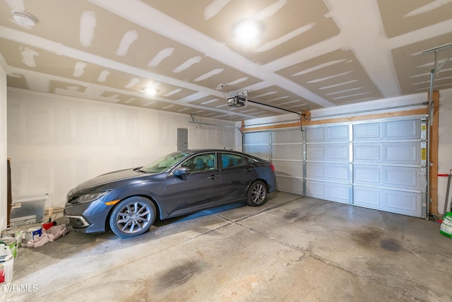 garage with electric panel and a garage door opener