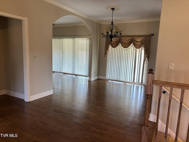 empty room with baseboards, a chandelier, dark wood-style flooring, and ornamental molding