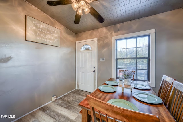 dining space with ceiling fan, baseboards, and wood finished floors