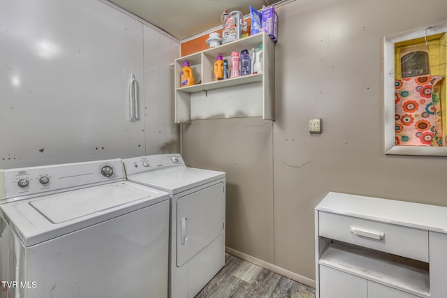 clothes washing area featuring laundry area, separate washer and dryer, and light wood-style floors