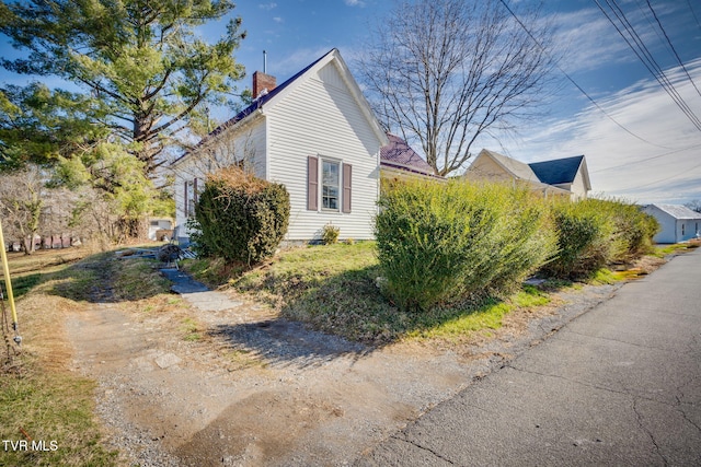 view of property exterior featuring a chimney