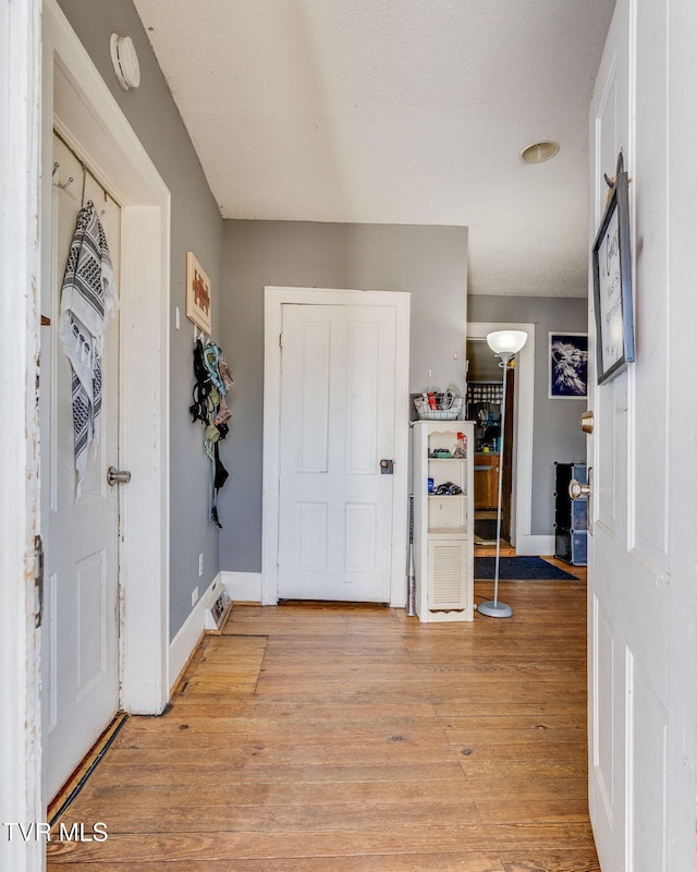 entrance foyer featuring light wood finished floors and baseboards