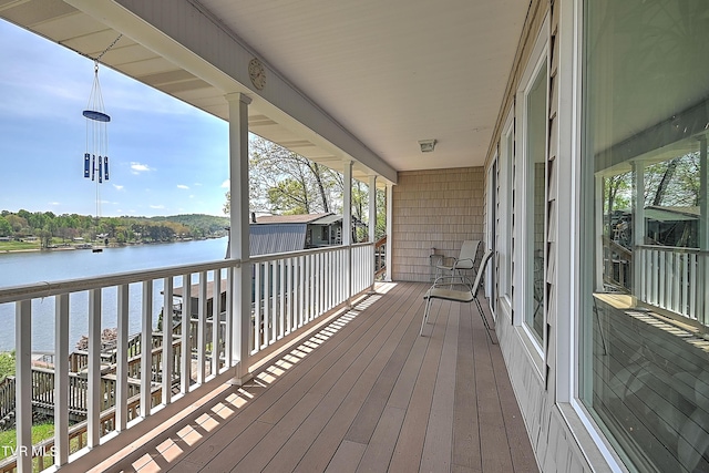 wooden terrace featuring a water view