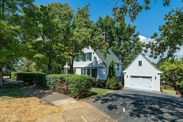 view of front of house with a garage, driveway, and brick siding