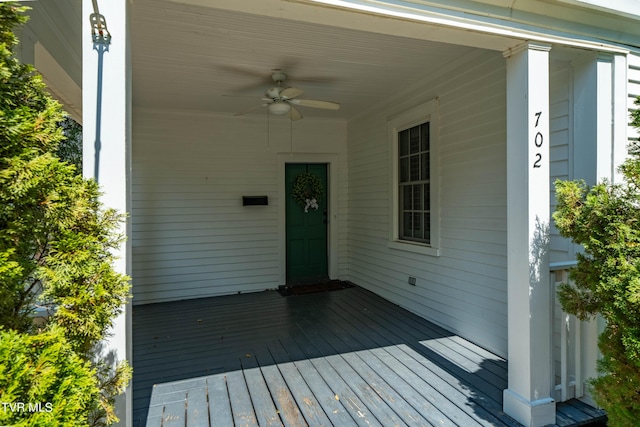 wooden deck with a ceiling fan