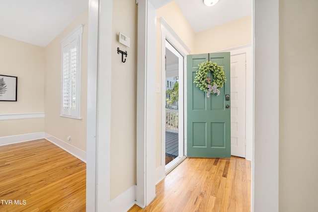 entryway featuring baseboards and wood finished floors