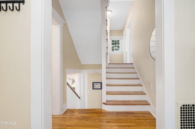 stairs featuring visible vents and wood finished floors