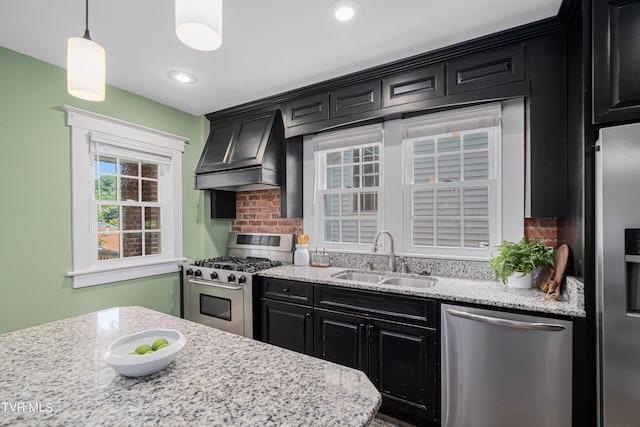 kitchen featuring stainless steel appliances, premium range hood, a sink, and dark cabinets