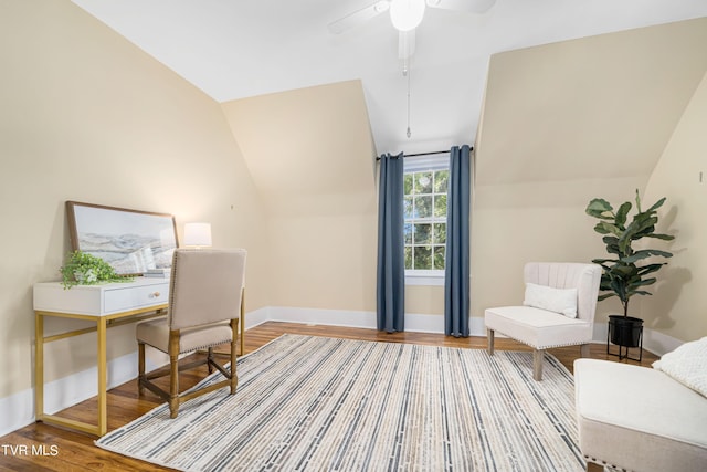 home office with lofted ceiling, a ceiling fan, baseboards, and wood finished floors