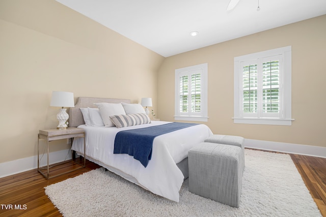 bedroom with baseboards and wood finished floors