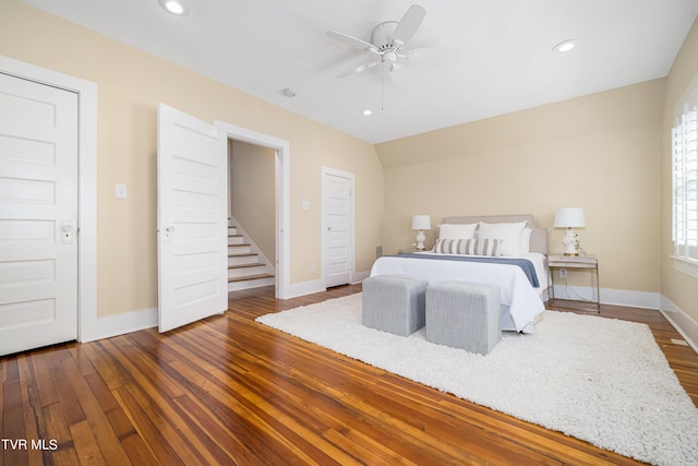 bedroom featuring dark wood-type flooring, recessed lighting, ceiling fan, and baseboards