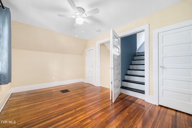 bonus room featuring visible vents, a ceiling fan, vaulted ceiling, baseboards, and dark wood finished floors