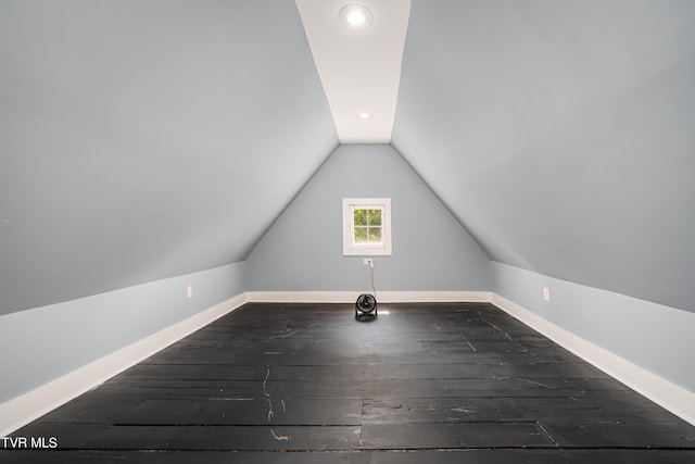 additional living space featuring vaulted ceiling, baseboards, and hardwood / wood-style flooring