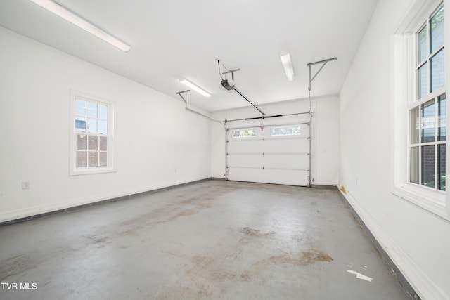 garage with baseboards and a garage door opener