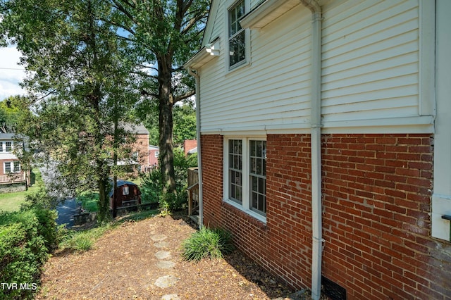 view of side of property featuring brick siding