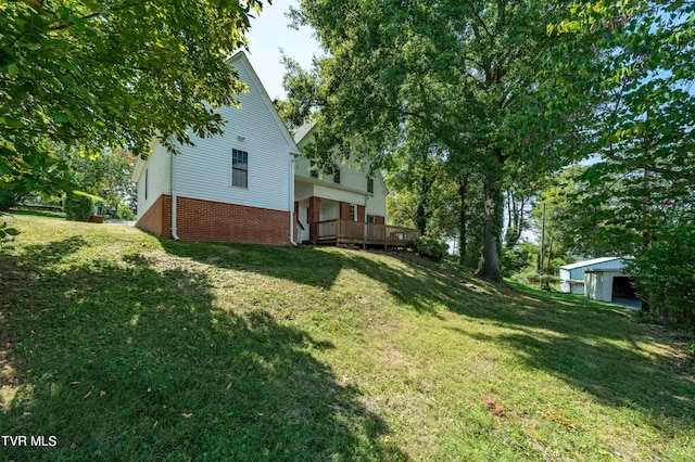 view of yard with an outbuilding and a deck