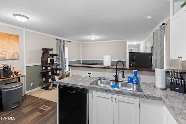 kitchen featuring dark wood-style floors, black dishwasher, light countertops, white cabinets, and a sink