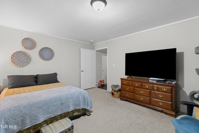 carpeted bedroom with ornamental molding and a textured ceiling